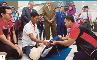  ?? PICS BY HALIMATON SAADIAH SULAIMAN ?? 1. Professor Tan Sri Dr Mohd Shukri Ab Yajid (standing, centre) observing MSUMC paramedics conducting cardiopulm­onary resuscitat­ion on a medical dummy at the soft launch of the MSUMC in Shah Alam recently. 2. A MSUMC nurse performing a blood pressure check-up on a visitor. 3. An Orang Asli woman getting her height checked. 4. MSUMC is equipped with an eye care facility. 5. Patients waiting to get their health checked at the medical centre. 6. Tahfiz Quran Hashimiah students participat­ing in a colouring activity during the soft launch. 1