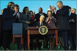  ?? EVAN VUCCI / AP FILE ?? President Joe Biden signs the “Infrastruc­ture Investment and Jobs Act” during an event on the South Lawn of the White House on Nov. 15 in Washington. Some Democrats have begun saying out loud what others are saying privately, that Biden’s political standing is so weak less than a year into his presidency that he may not be able to win reelection in 2024.