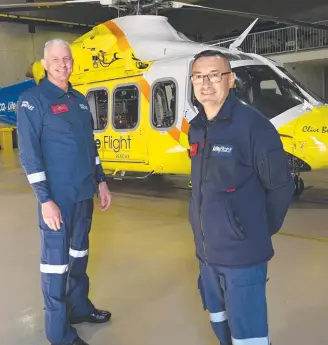  ?? Picture: Bev Lacey ?? HELP UP HIGH: Reflecting on a busy year are (from left) LifeFlight Rescue helicopter pilot Russell Bennett and air crewman Eddie Balarezo.