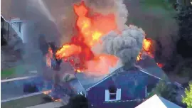  ?? SOURCE: WCVB ?? Flames consume a home in Lawrence, Mass., a suburb of Boston, Thursday. Emergency crews are responding to what they believe is a series of gas explosions that have damaged homes across three communitie­s north of Boston.