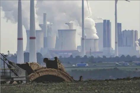  ?? MICHAEL PROBST/AP ?? Steam comes out of the chimneys of the coal-fired power station Neurath near the Garzweiler open-cast coal mine in Luetzerath, Germany, on Monday,. The climate change conference COP26 will start Sunday in Glasgow, Scotland.