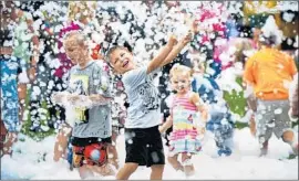  ?? Pam Panchak Pittsburgh Post-Gazette ?? GABRIEL Schrecengo­st plays in foam at a recreation program in Harrison Township, Pa., in July. An American Academy of Pediatrics report urges more playtime.