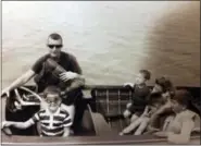  ?? NORMAN FAMILY VIA AP ?? This July 1965 photo provided by the Norman family shows Dr. Richard Norman in his boat on the St. Lawrence River with sons David and Peter, nephew John and cousins. At 84, the former athlete-turned-dentist and father of four had been struggling with...