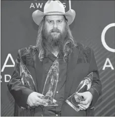  ?? AP PHOTO ?? Singer/songwriter Chris Stapleton poses in the press room with the male vocalist of the year, song of the year and single of the year awards at the 52nd annual CMA Awards on Wednesday.