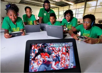  ?? Associated Press ?? ■ Portrait of Southern Lab School’s Esports gaming team members and their adviser/coach pose for a portrait Sept. 17 in Baton Rouge, La. From left, Demitra Hawkins, 13, Kameron Tillage, 12, advisor/coach Christophe­r Turner, Dacorion Marioneaux, 15, Cristion Henry, 16 and Cornelius Pointer, 17, in Baton Rouge, La.