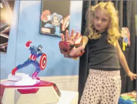  ?? Damian Dovarganes Associated Press ?? WEARABLE TECH as part of Playmation takes the form of a “repulsor” glove, through which users get exercise in taking on the role of Iron Man.