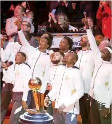  ?? VERONICA HENRI ?? Raptors players look on in awe during the ring ceremony as the team raises the NBA championsh­ip banner to the rafters before Tuesday’s 130-122 overtime win over the New Orleans Pelicans.