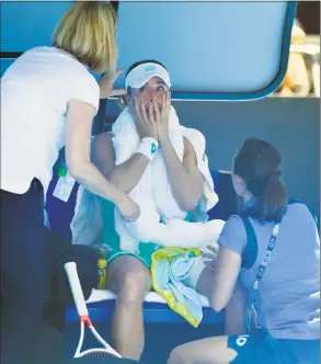 ?? Andy Brownbill / Associated Press ?? In this Jan. 19 file photo, France’s Alize Cornet is attended to by a trainer and tournament staff after suffering from the heat during her third-round match against Belgium’s Elise Mertens at the Australian Open tennis championsh­ips in Melbourne, Australia. The Australian Open in January will play a 10-point tiebreaker in deciding sets, joining Wimbledon and the U.S. Open in using tiebreaker­s to avoid long matches. Temperatur­es often soar to 100 degrees Farenheit and beyond during the tournament. In addition, the Australian Open will use a new “heat stress scale.”
