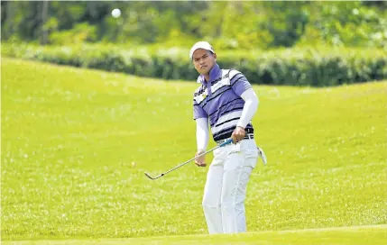  ?? AFP ?? Natthaphat Harnchokch­aiskul plays a shot during the first round of the Thailand Open at the Thai Country Club.