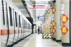  ??  ?? A member of the security personnel stands on duty on an empty train platform inside a station on the Subway Line Number 1 in Beijing, China. — Reuters photo