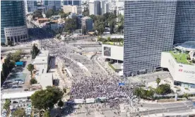  ?? Photograph: Ilan Rosenberg/Reuters ?? Thousands of protesters block a main road in Tel Aviv during a ‘day of disruption’ on 1 March.