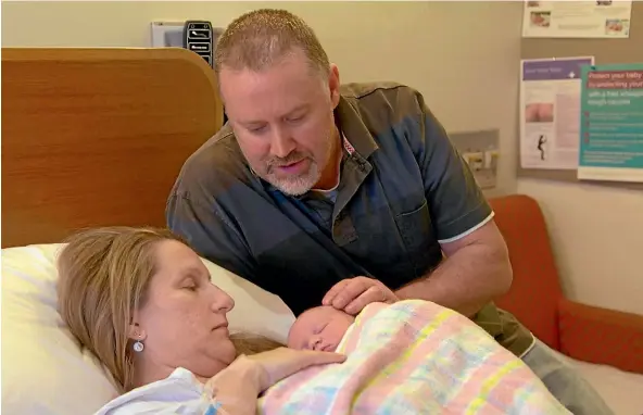  ?? 60 MINUTES ?? Olivia and Andrew Densley admire their daughter Lilliahna who was geneticall­y engineered to become a bone-marrow donor for 4-year-old Fletcher, above.