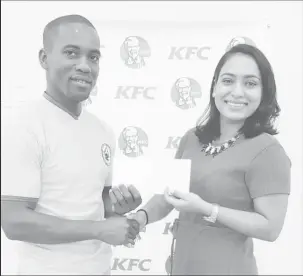  ??  ?? Korean Internatio­nal Chairman Roland Eudoxie receives the sponsorshi­p cheque from KFC Marketing Manager, Lavasti Bhooplall.
