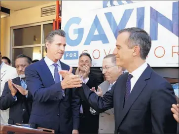  ?? Al Seib Los Angeles Times ?? LOS ANGELES MAYOR Eric Garcetti, right, endorses Lt. Gov. Gavin Newsom for California governor last month. Past colleagues have criticized the Democratic front-runner for several of his about-faces on top issues.