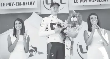  ??  ?? Great Britain’s Christophe­r Froome celebrates his overall leader yellow jersey on the podium at the end of the 189.5 km fifteenth stage of the 104th edition of theTour de France cycling race between Laissac-Severac l’Eglise and Le Puy-en-Velay. - AFP...