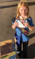  ?? The Canadian Press ?? Nine-year-old Elina Childs sells Girl Guide cookies outside a cannabis store in Edmonton on Wednesday.