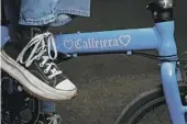  ?? ?? MICHELLE MORO, top, traverses the streets of her native South L.A. on a blue foldable bike, above, sharing her journeys with her followers.