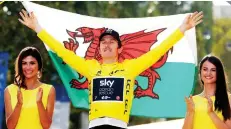  ??  ?? File photo shows Team Sky rider Geraint Thomas of Britain celebrates his overall victory on the podium with a Welsh flag during Tour de France - The 116-km Stage 21 from Houilles to Paris Champs-Elysees in July 29, 2018. — Reuters photo