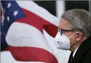  ?? J.D. POOLEY — SENTINEL-TRIBUNE VIA AP ?? Ohio Gov. Mike DeWine looks on during a press conference Wednesday, Nov. 18, at Toledo Express Airport in Swanton.