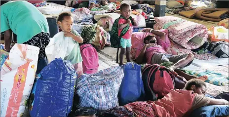  ?? Pictures: REUTERS ?? RESTED: Residents evacuated with their possession­s at an evacuation centre in Luganville yesterday.