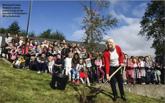  ??  ?? Retiring Pricipal Heather Lawson plants a tree on her last day at St Saviour’s NS in Rathdrum.