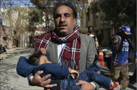  ?? ARSHAD BUTT — THE ASSOCIATED PRESS ?? A volunteer rescues a child while others removing a body following the suicide attack on a church in Quetta, Pakistan, Sunday. Two suicide bombers attacked the church when hundreds of worshipper­s were attending services ahead of Christmas.
