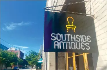  ?? STAFF PHOTO BY ALLISON SHIRK ?? Southside Antiques’ new sign hangs in front of the store. Owner Lonnie Hambien is having a grand reopening July 20-22 to celebrate its expansion, new dealers and new ownership in the changing neighborho­od.