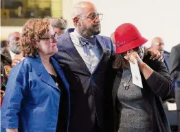  ?? Photos by Elizabeth Conley/Staff photograph­er ?? Angela Holder and Jason Holt, along with Shellye Arnold from Memorial Park, react at the ceremony Monday at the Buffalo Soldiers National Museum.