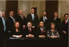  ?? Julia Malakie / Associated Press ?? Mayor Sokhary Chau (front row, second from right) poses with other members of the City Council in Lowell, Mass.