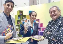  ??  ?? Program host Abderrahim Aitalia and Ruba of the organizing committee receive Philippine materials from guest speaker and author Krip Yuson.