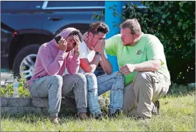  ?? PATRICK SEMANSKY/AP PHOTO ?? People gather across the street from the scene of a shooting at a business park in the Edgewood area of Harford County, Md., on Wednesday.