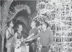  ?? LIGHTS ON. ?? The lights of the Mandani Bay Christmas Tree were switched on by (from left) HTLand, Inc. President Jack Gaisano, his wife, Vivian, Mandani Bay Project Director Gilbert Ang and Sales Head Audi Villa. The 30-foot tree is made of balls of lights and is...