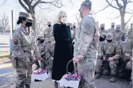  ?? JACQUELYN MARTIN/AP ?? First lady Jill Biden meets with and thanks National Guard members for helping protect her family Friday outside the U.S. Capitol in Washington, D.C.