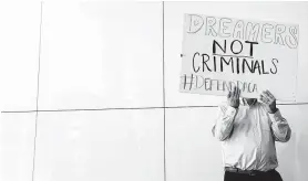  ?? Jon Shapley / Houston Chronicle ?? A man displays a sign at the Mickey Leland Federal Building calling for action to help DACA recipients.