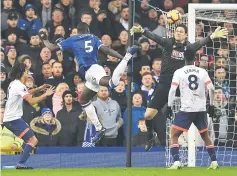  ??  ?? Everton’s French defender Kurt Zouma (second left) heads the ball to score the opening goal during the English Premier League football match between Everton and Bournemout­h at Goodison Park in Liverpool, north west England. — AFP photo