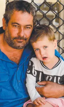  ?? SAFETY FIRST: Paul Felesina, with three- year- old son William, has had to purchase bottled water. ??