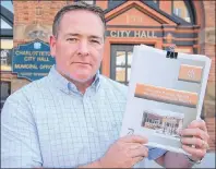  ?? JIM DAY/THE GUARDIAN ?? Charlottet­own Coun. Bob Doiron holds a report released Wednesday that is highly critical of Peter Kelly, the city’s CAO, during his run in that same position for an Alberta municipali­ty. Doiron says Charlottet­own residents have frequently voiced...