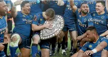  ?? GETTY IMAGES ?? Otago captain Michael Collins cradles the Shield yesterday.