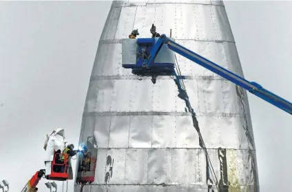  ?? Miguel Roberts / Brownsvill­e Herald ?? SpaceX continues work on its prototype Starship at the Boca Chica beach site near Brownsvill­e. SpaceX selected Boca Chica for a commercial launch site due to its proximity to the equator and distance from populated areas.The Starship, integrated with the Super Heavy Rocket, previously called BFR, is expected to be more powerful than the Saturn V rocket that NASA used to propel astronauts to the moon.