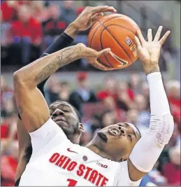  ?? [TYLER SCHANK/DISPATCH] ?? Michigan State’s Aaron Henry fouls Ohio State’s Luther Muhammad during the first half.