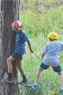  ??  ?? STEADY ON: St Augustine's College students Joshua Long and Cameron Boyden tackle the ropes course on Year 7 camp.