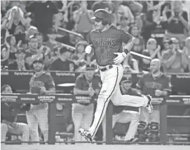 ?? DAVID KADLUBOWSK­I/AZCENTRAL SPORTS ?? The Diamondbac­ks’ A.J. Pollock rounds the bases after his solo home run against the Cincinnati Reds in the third inning Sunday in Phoenix.