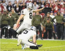  ?? Jennifer Stewart / Getty Images ?? The Raiders’ Daniel Carlson kicks the game-winning, 35-yard field goal against the Cardinals on Nov. 18.