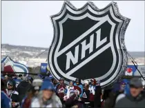  ?? ASSOCIATED PRESS FILE PHOTO ?? Fans pose below the NHL league logo at a display outside Falcon Stadium before a 2020NHL Stadium Series outdoor game between the Los Angeles Kings and Colorado Avalanche at Air Force Academy, Colo.