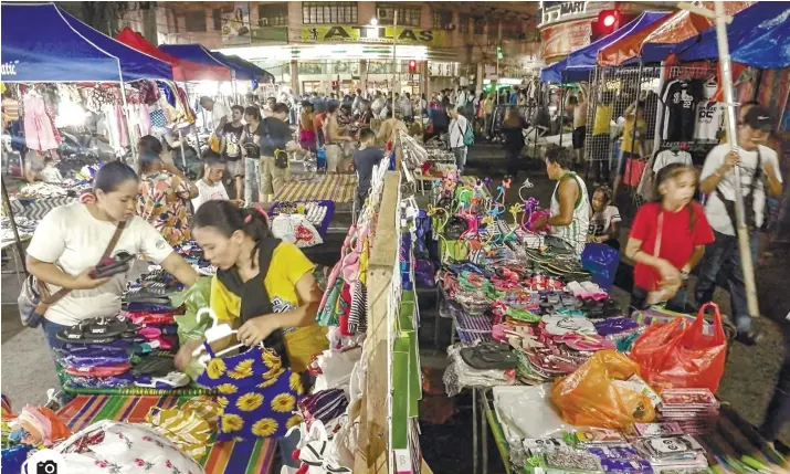  ?? Photo by Arni Aclao ?? DOWNTOWN DEALS. With the holidays approachin­g, shoppers have more options for their shopping needs, including the Night Market on Colon St. where great bargains await frugal shoppers who are looking to save a few pesos.