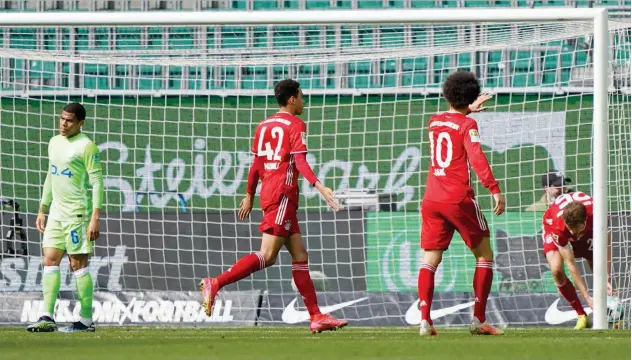  ?? Associated Press ?? ↑
Bayern Munich’s Jamal Musiala (centre) celebrates after scoring a goal against VFL Wolfsburg during their German League match on Saturday.