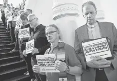  ?? JAY JANNER, AUSTIN AMERICAN- STATESMAN, VIA AP ?? Members of the clergy pray outside the House chamber in Austin in opposition to bills they consider anti- LGBT.