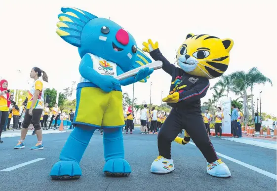  ??  ?? 2018 Commonweal­th Games mascot Borobi will explore Gold Coast tourism attraction­s this week with South East Asian Games tiger mascot Rimau.