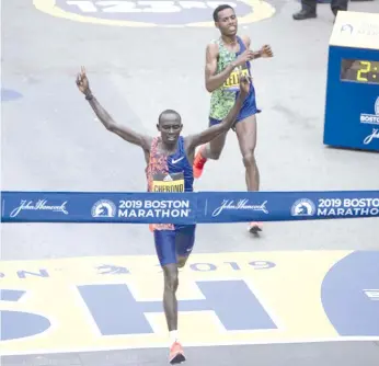  ?? - AFP photo ?? Kenyan Lawrence Cherono edgesEthop­ian Lelisa Desisa for the 2019 Boston Marathon title. The 2020 edition has been cancelled after originally being reschedule­d for September because of Covid-19.