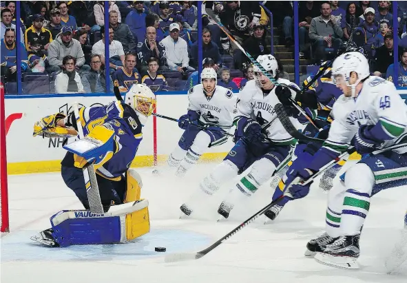  ?? — GETTY IMAGES ?? St. Louis Blues goaltender Jake Allen moves to make a stop on Vancouver Canucks centre Jayson Megna on Thursday night in St. Louis. Allen stopped 18 of 21 shots and the Blues won 4-3, thanks in part to two quick goals in the early part of the third...